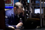 Wall Street falls 1 percent on earnings; Apple rallies late